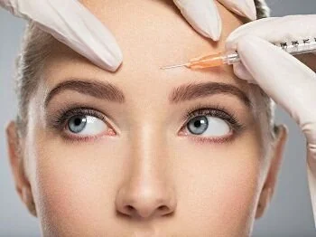 A Botox injection being given between the eyebrows